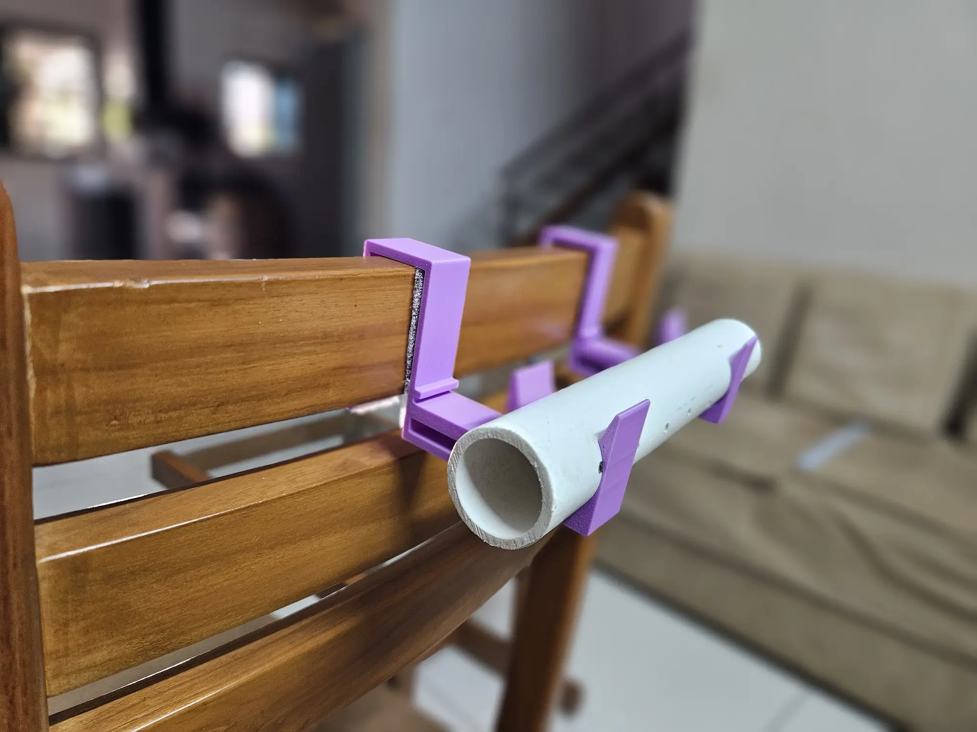 The bracket in use on a chair with the support pipe snapped into it